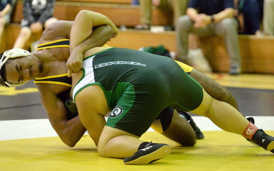Kadena's Tre Shears gets the advantage on Kubasaki's Erich Aquino at 189 pounds during Wednesday's Okinawa wrestling dual meet. Shears won by technical fall and the Panthers won the meet.