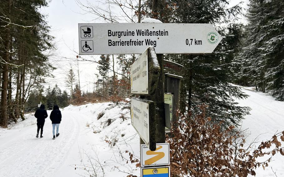 Hikers make their way through the snow to the Weissenstein Castle ruins in Steinwald Nature Park in Waldershof, Germany, on Jan. 11, 2025. 