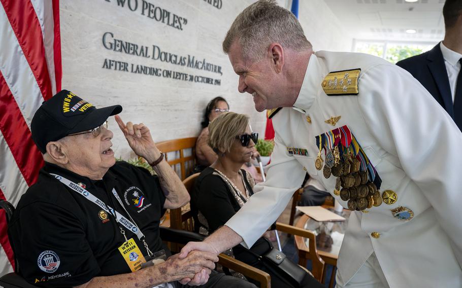 Adm. Samuel Paparo, the head of U.S. Indo-Pacific Command, greets Navy veteran Arthur Grabiner.