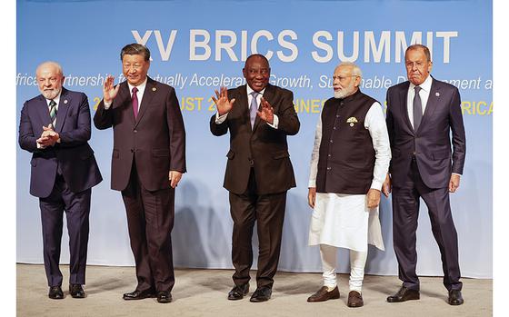 From left, Brazil President Luiz Inacio Lula da Silva, China President Xi Jinping, South African President Cyril Ramaphosa, Prime Minister of India Narendra Modi and Russia's Foreign Minister Sergei Lavrov pose for a BRICS family photo during the 2023 BRICS Summit at the Sandton Convention Centre in Johannesburg, South Africa, Wednesday, Aug. 23, 2023. (Gianluigi Guercia/Pool via AP)