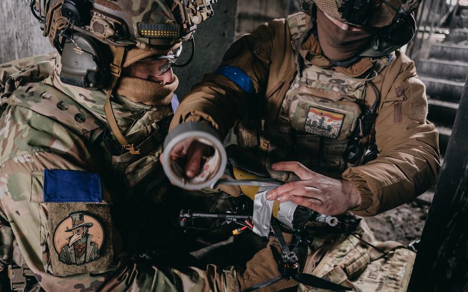 Members of Alpha unit prepare FPV drones at the Avdiivka plant.