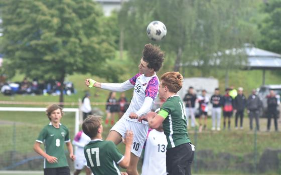 American Overseas School of Rome's Ouael Fartas gets a head on the ball before Naples Camden Kasparek can get to it Wednesday, May 22, 2024, in the semifinals of the DODEA European Division II boys soccer championships at Reichenbach-Steegen, Germany.