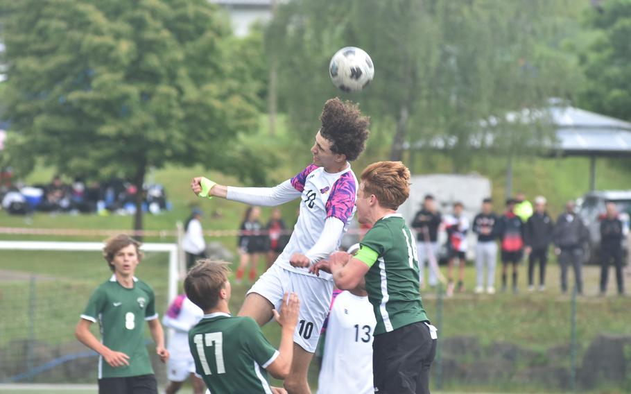 American Overseas School of Rome's Ouael Fartas gets a head on the ball before Naples Camden Kasparek can get to it Wednesday, May 22, 2024, in the semifinals of the DODEA European Division II boys soccer championships at Reichenbach-Steegen, Germany.