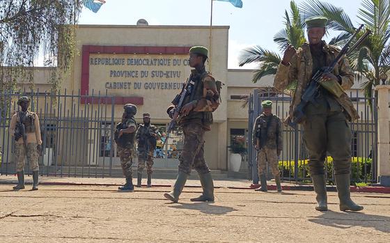 M23 rebels guard outside the South Kivu province administrative office, at the centre of east Congo's second-largest city, Bukavu, Sunday, Feb. 16, 2025. (AP Photo/Janvier Barhahiga)