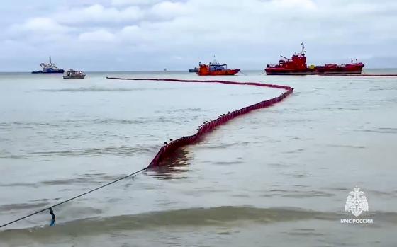 In this photo taken from video released by the Russian Emergency Ministry Press Service on Sunday, Jan. 12, 2025, booms are visible on the sea around the damaged Volgoneft-239 tanker near the port of Taman where Russian rescuers work to clean up tons of fuel oil that spilled out of two storm-stricken tankers more then three weeks ago in Russia's southern Krasnodar region. (Russian Emergency Ministry Press Service via AP)