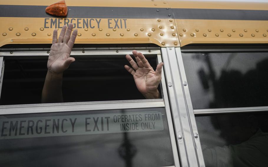 Nicaraguan citizens wave from a bus