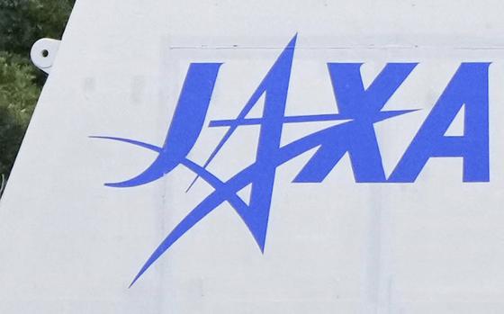 A logo that reads ‘JAXA’ is seen in blue against a white background.