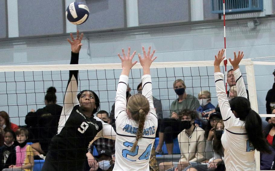 Humphreys' Sabra Wrightsil spikes against Osan's Anne Mountcastle and Chamille Gley during Saturday's DODEA-Korea girls volleyball final, which the Blackhawks won in four sets.