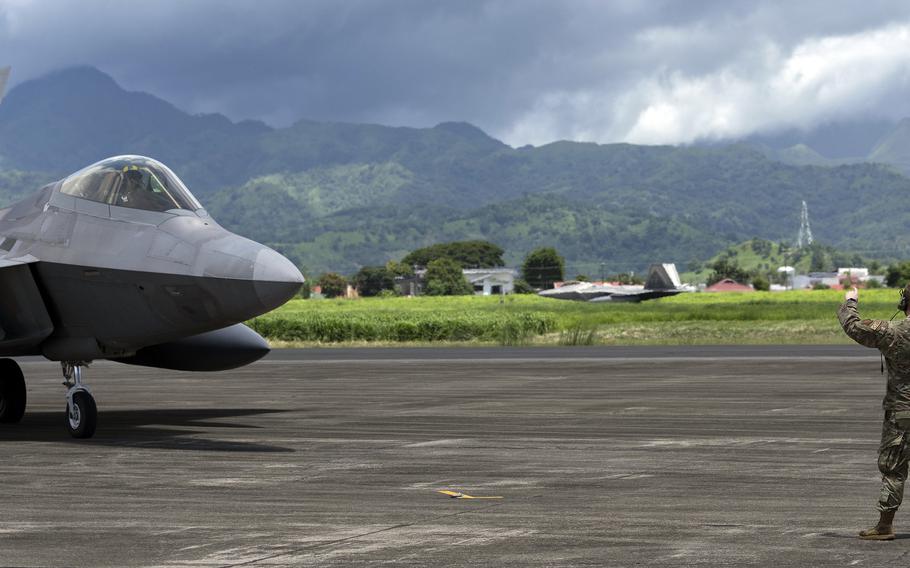 Senior Airman Emmitt Niemi marshals an F-22 Raptor from the 27th Expeditionary Fighter Squadron at Basa Air Base, Philippines, Aug. 8, 2024.