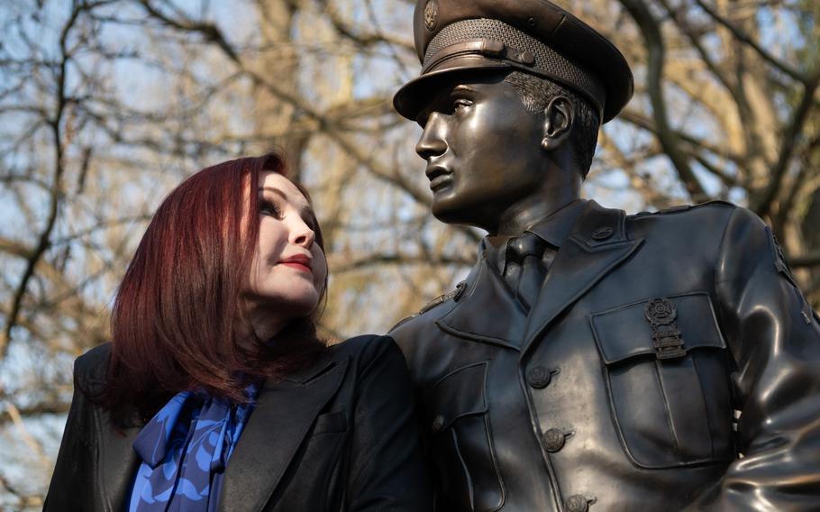 Priscilla Presley looks up at a Bad Nauheim statue of her former husband, Elvis Presley.