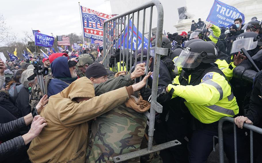 Supporters of then-President Donald Trump try to force their way through a police barricade in front of the U.S. Capitol on Jan. 6, 2021, hoping to stop Congress from finalizing Joe Biden’s victory in the 2020 presidential election. 