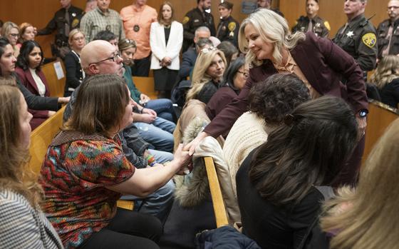 FILE - Oakland County Prosecutor Karen McDonald, right, shakes hands with Oxford High School victim parents after Jennifer Crumbley was found guilty on four counts of involuntary manslaughter in the Oakland County courtroom, Feb. 6, 2024 in Pontiac, Mich. (Mandi Wright/Detroit Free Press via AP, Pool, File)