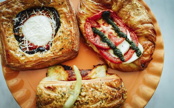 Pastries at Layers Artisan Croissanterie in Manama, Bahrain, include, clockwise from top right, the Caprese Danish with fresh pesto and tomatoes, pain Suisse with roast beef and cheese, and the eggplant Parmesan Danish. Each of the pastries at Layers is made daily.