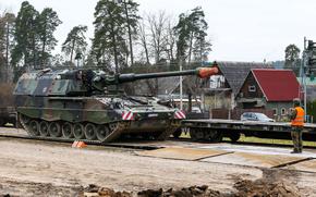 An undated image shows a German soldier guides the loading of a Panzerhaubitze 2000 onto a railway car during an exercise in Lithuania. Germany had 2,398 battle tanks in 2004 compared with 339 in 2021, according to Kiel Institute researchers who say that Berlin isn't rearming quickly enough to counter Russia.