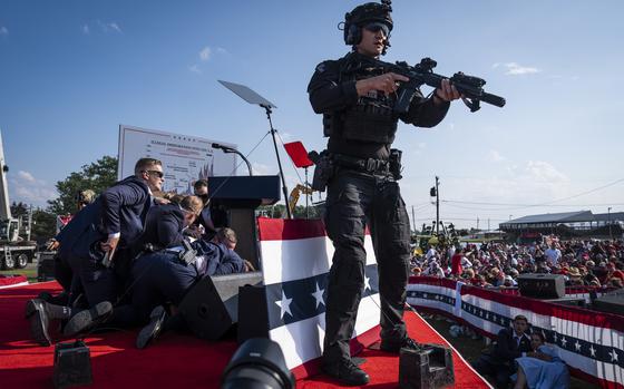 Secret Service agents and security personnel react moments after shots were fired toward Donald Trump. MUST CREDIT: Jabin Botsford/The Washington Post