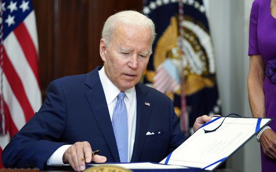 President Joe Biden signs into law S. 2938, the Bipartisan Safer Communities Act gun safety bill, in the Roosevelt Room of the White House in Washington, June 25, 2022. More than 500 people have been charged with federal crimes under new firearms trafficking and straw purchasing laws that are part of the landmark gun safety legislation President Joe Biden signed two years ago Tuesday. Some of the people were linked to transnational cartels and organized crime. That's according to a White House report obtained by The Associated Press. 