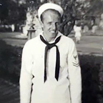 A black-and-white, 1940s-era image of a Navy sailor posing in uniform.