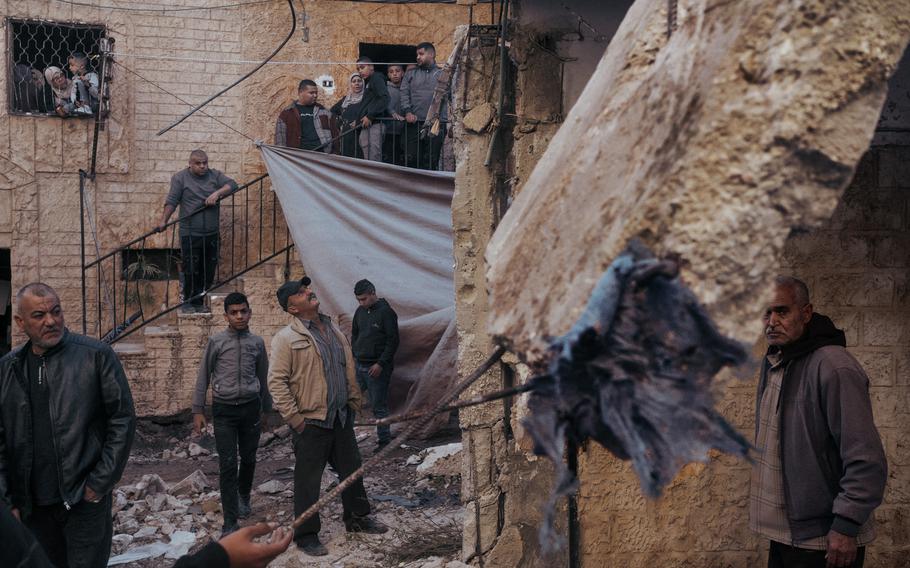 Civilians gather in the heavily damaged al-Damaj neighborhood on Nov. 30, 2023.