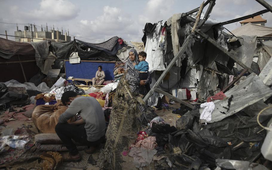 Displaced Palestinians inspect their tents destroyed by Israel’s bombardment near Rafah in the Gaza Strip on May 28, 2024. 