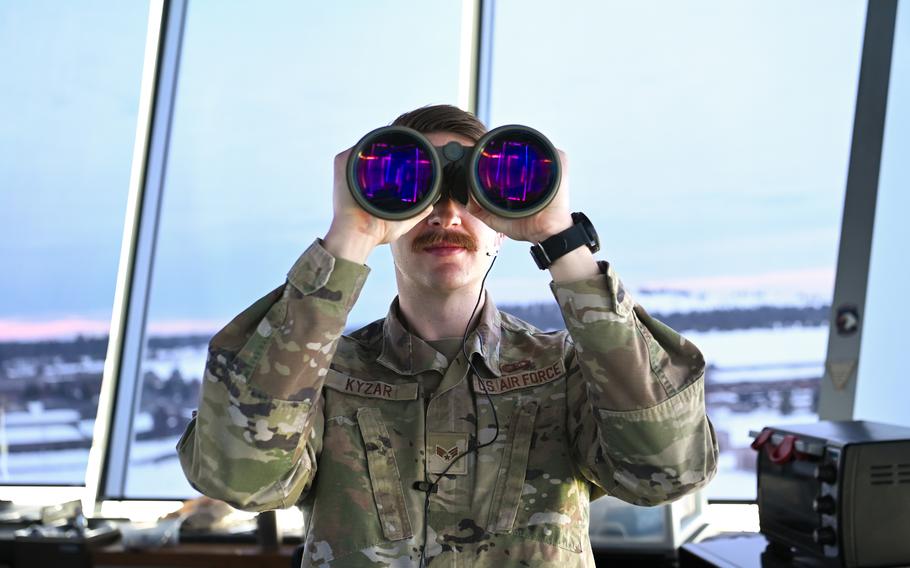 Senior Airman Brent Kyzar, 92nd Operations Support Squadron air traffic control apprentice, uses his binoculars to locate aircraft on the flightline at Fairchild Air Force Base, Wash., Jan. 5, 2023. ATC Airmen are responsible for clearing pilots during takeoff and landing and also play a significant role in communicating vital flight patterns and weather information.