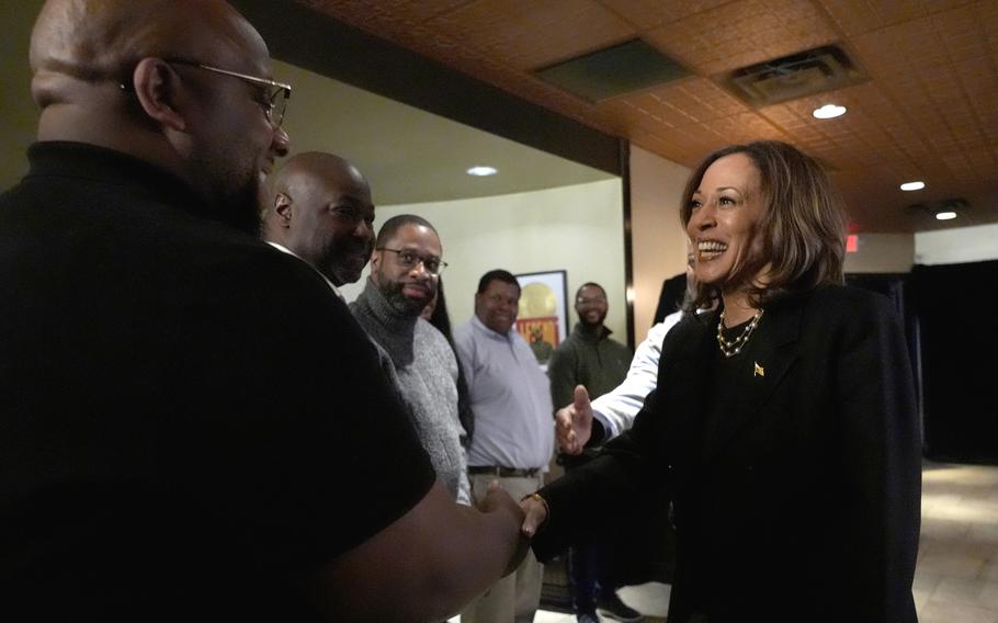 Kamala Harris shakes hands with a voter during a campaign stop.