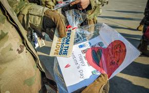 An American soldier holds a Valentine’s Day card.