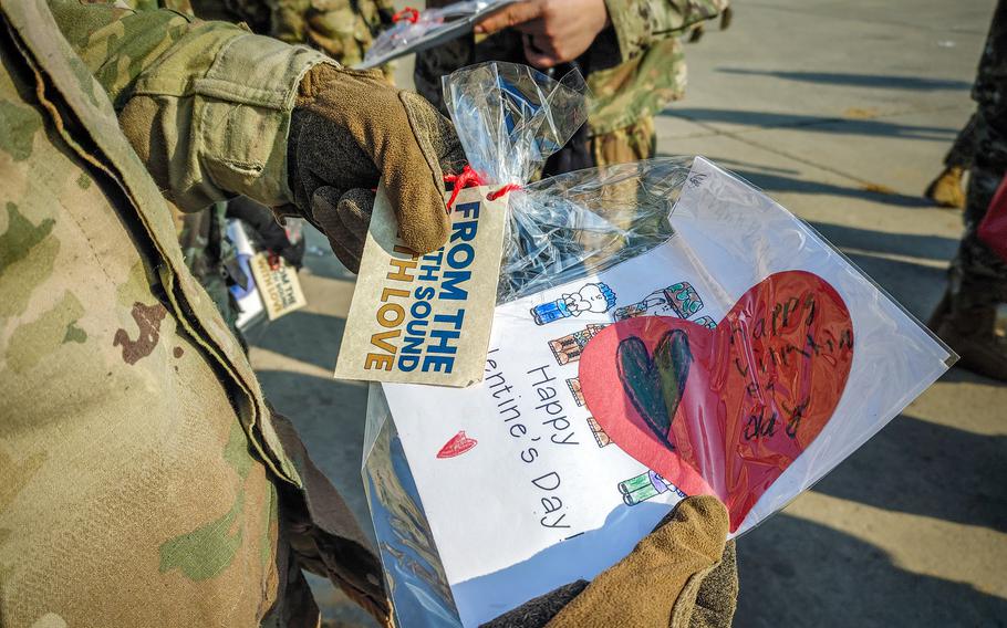 An American soldier holds a Valentine’s Day card.