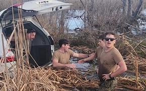 NEW ORLEANS (Feb. 6, 2024) – U.S. Navy Seabees assigned to Naval Mobile Construction Battalion (NMCB) 11 recover personal effects from a submerged vehicle after carrying its occupants to safety outside of New Orleans, Feb. 6, 2024. NMCB-11, assigned to Naval Construction Group TWO, is homeported in Gulfport, Ms. as part of the Naval Construction Force. (U.S. Navy photo by Electronics Technician 2nd Class Tiara Mickalowksi)