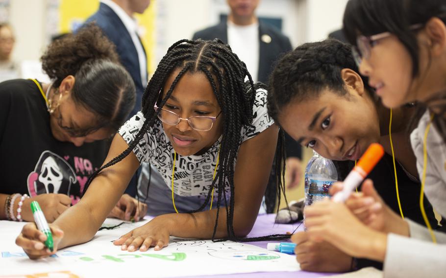 American students Layla Springs, 16, left, and Rosa Thompson, 15, middle left, work with Japanese students Cocomi Trinity Gibson, 16, middle right, and Yuina Nishiba, right, during the Student Educational Exchange and Dialogue  at Matthew C. Perry High School, Marine Corps Air Station Iwakuni, Japan, Sept. 8, 2024.