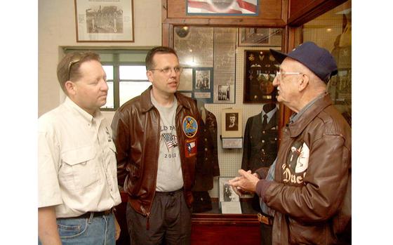 Don "Duck" Bradley, right, talks to two British visitors at the 100th Bomb Group Memorial Museum. Bradley served as the photo chief and aerial photographer, 350th Bomb Squadron, 100th Bomb Group, flying a total of 29 missions between 1942 - 1945. About 20 World War II veterans and their families visited the site June 22, 2002.

Read about their visit and the memories they recalled in Ron Jensen's original article here. 