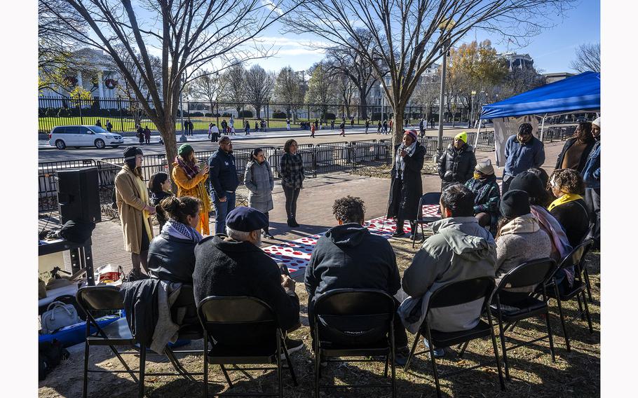 Ciara Taylor, center right with microphone, of the Kairos Center for Religions, Rights and Social Justice, speaks as state lawmakers and other advocates stage a hunger strike in front of the White House to demand a permanent cease-fire in the Israel-Gaza war. 