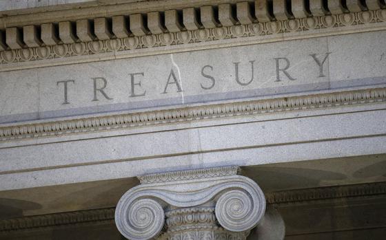 FILE- This photo shows the U.S. Treasury Department building at dusk in Washington, June 6, 2019. (AP Photo/Patrick Semansky, File)