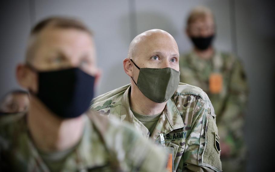 Army Reserve Col. Reece Roberts listens to a commander at Camp Williams, Utah, in 2021. Roberts pleaded guilty to stealing more than $62,000 in a housing fraud scheme. His sentencing is scheduled for August.