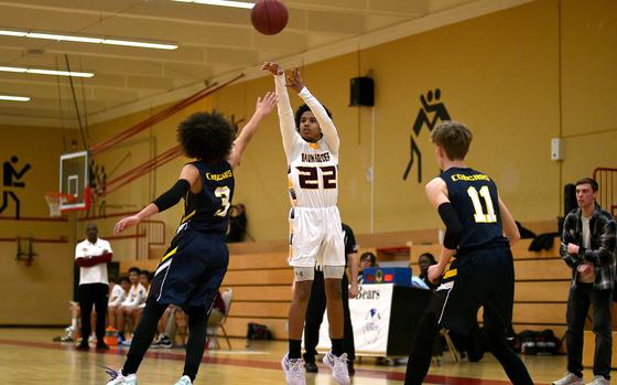 Baumholder's Artez Williams shoots a 3-pointer over Ansbach's Donovan Howard during a Jan. 24, 2025, contest at the Hall of Champions Physical Fitness Center in Baumholder, Germany.