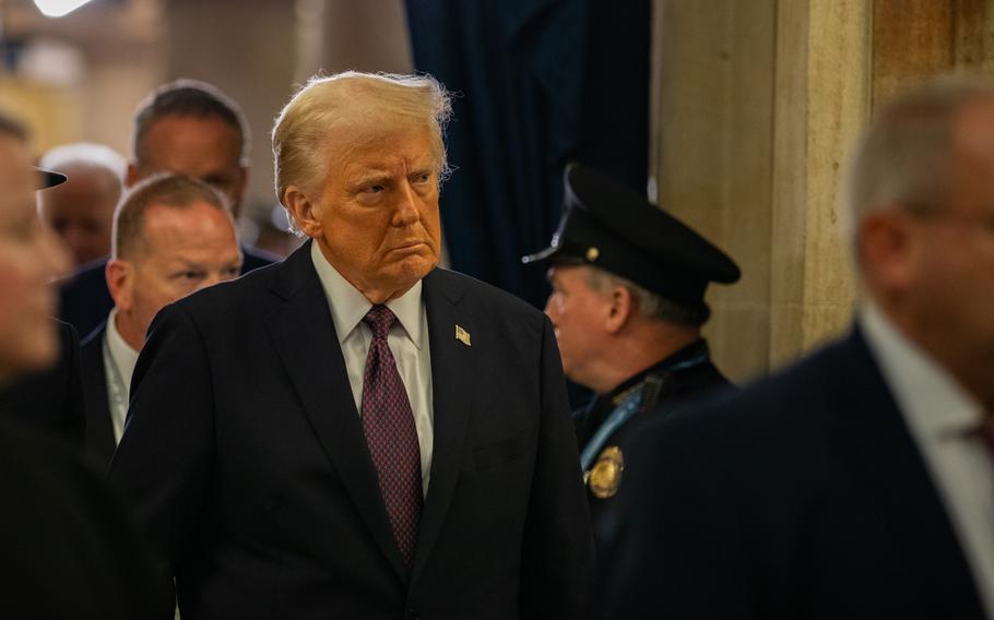 Trump walks through the Capitol.