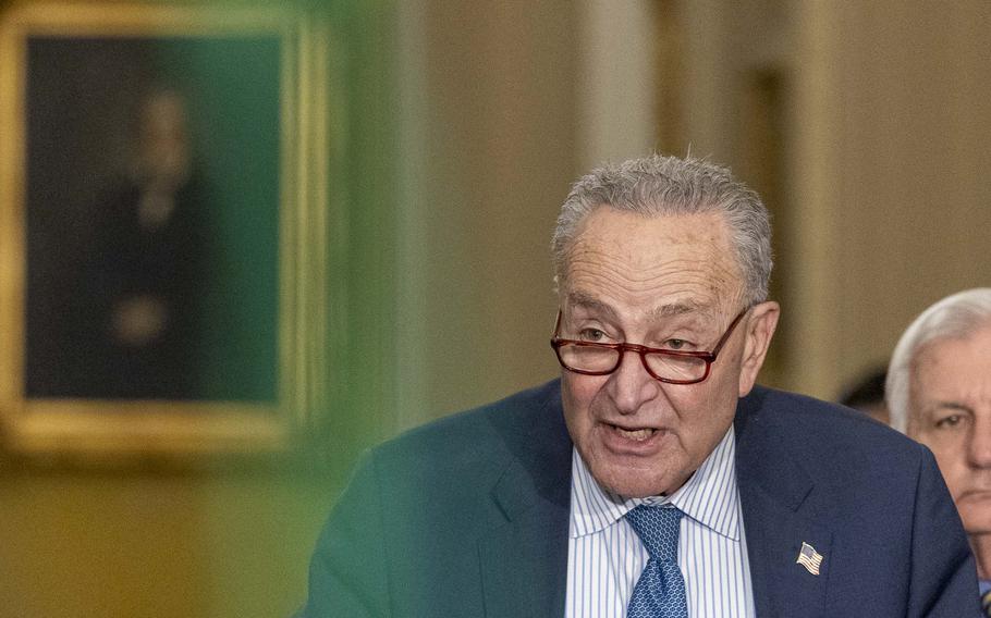 Sen. Charles Schumer looks past his glasses as he speaks.