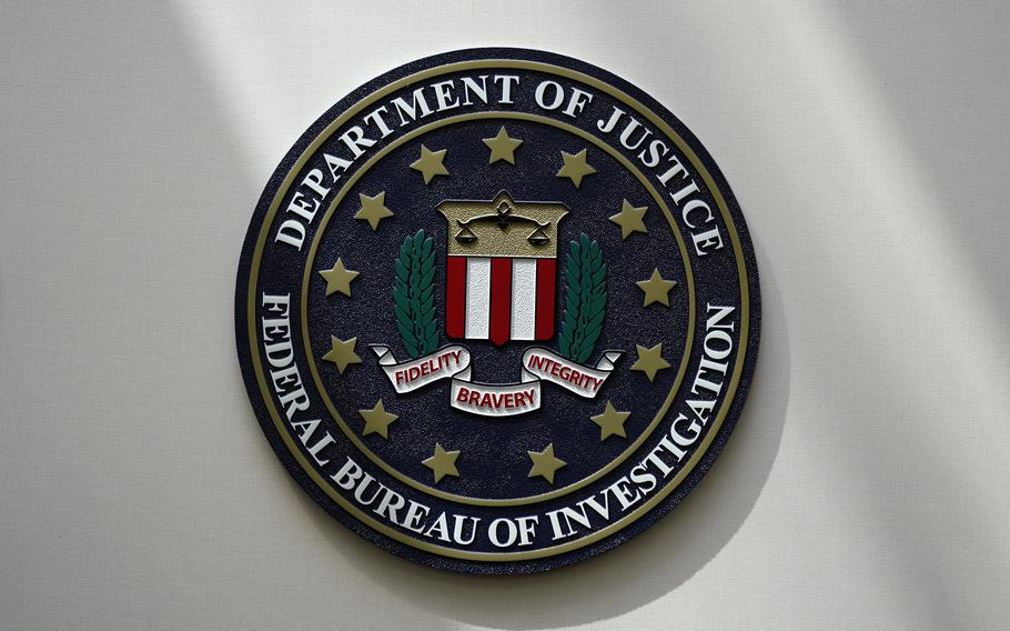 The seal of the FBI hanging on an office wall.