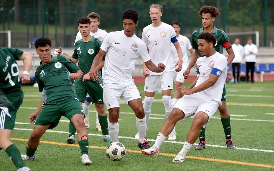 Ramstein midfielder Maxim Speed pokes the ball toward goal while SHAPE midfielder Jorge Nubla go to block it during the Division I final of the DODEA European championships on May 23, 2024, at Ramstein High School on Ramstein Air Base, Germany.