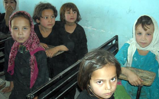 These students are part of the first generation of girls in a northern Afghanistan village to get an education at a school that opened in 2003. (Janese Hubbard/Seattle Times/MCT)