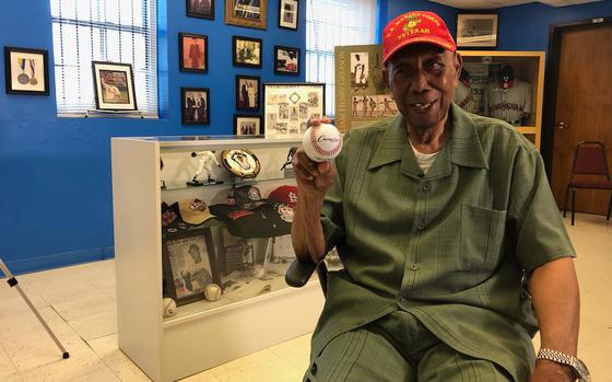 Bill Greason, who pitched for the Birmingham Black Barons from 1948-50 and the St. Louis Cardinals in 1954, poses with memorabilia  from his career.