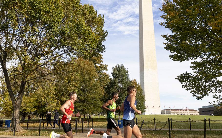 Kyle King, left, and runner-up George Crist, foreground, pass the Washington Monument 