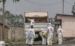 Red Cross personnel load bodies of victims of the fighting between Congolese government forces and M23 rebels in a truck in Goma, Democratic Republic of Congo, Monday, Feb. 3, 2025, as the U.N. health agency said 900 died in the fight. (AP Photo/Moses Sawasawa)