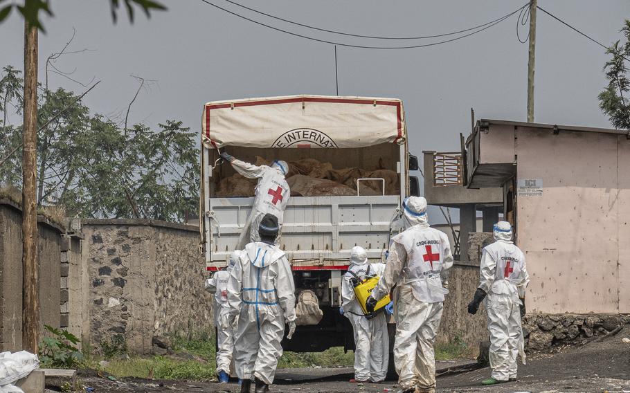 Red Cross personnel load bodies of victims