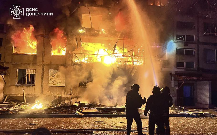 Firefighters try to put out a fire in a building.