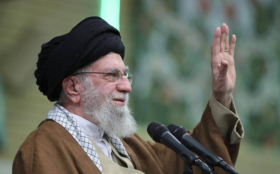 Ayatollah Ali Khamenei waves to the crowd.