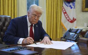 FILE - President Donald Trump signs a document in the Oval Office at the White House, Jan. 30, 2025, in Washington. (AP Photo/Evan Vucci, File)