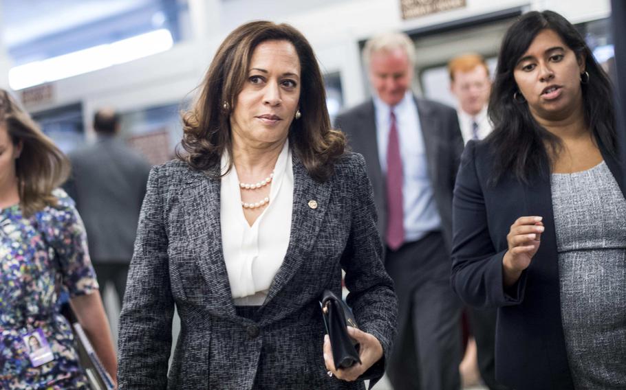 Then-Sen. Kamala Harris (D-Calif.) gets briefed by staff on the way to the Senate floor in July 2017.