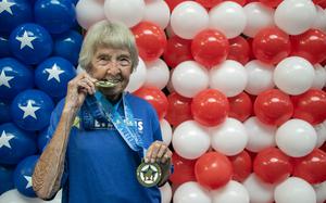 Betty St. John bites down on her 85th medal at the 2024 National Veterans Golden Age Games. The 85-year-old veteran proved that age is no barrier to staying fit and active.