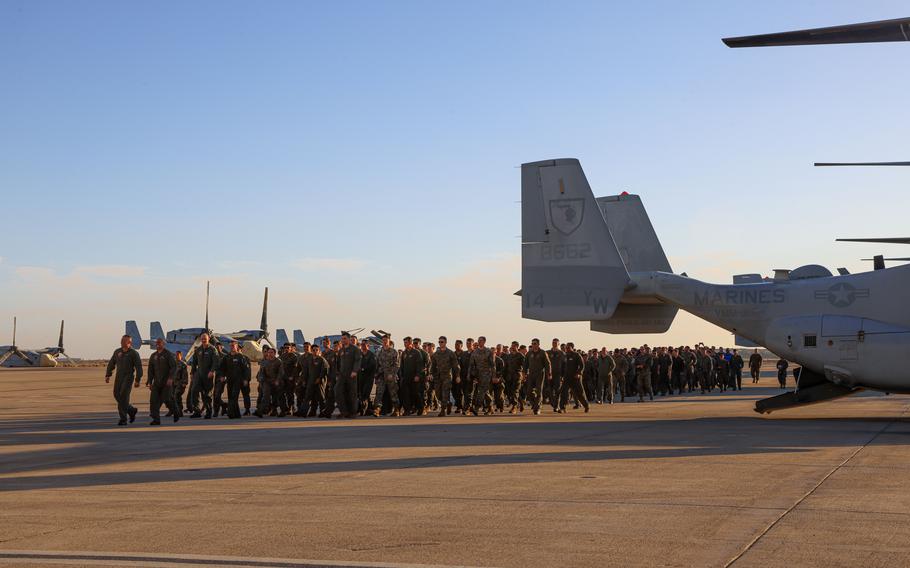 Marines walk the flight-line towards their families