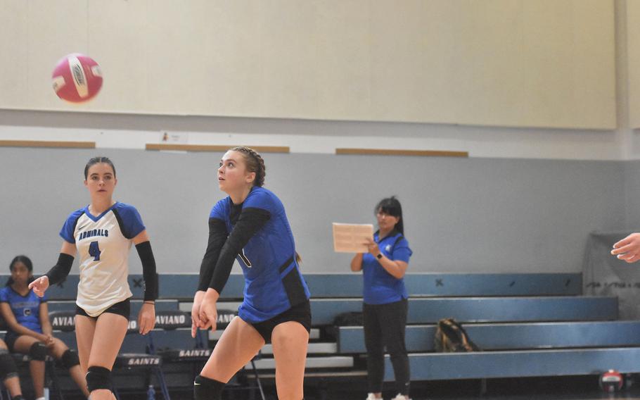 Rota’s Amaya Petty has her eyes on the ball as teammate Kate Warkentein watches her bump it up to the front row in the Admirals’ five-set victory Saturday, Oct. 14, 2023, over the Aviano Saints.